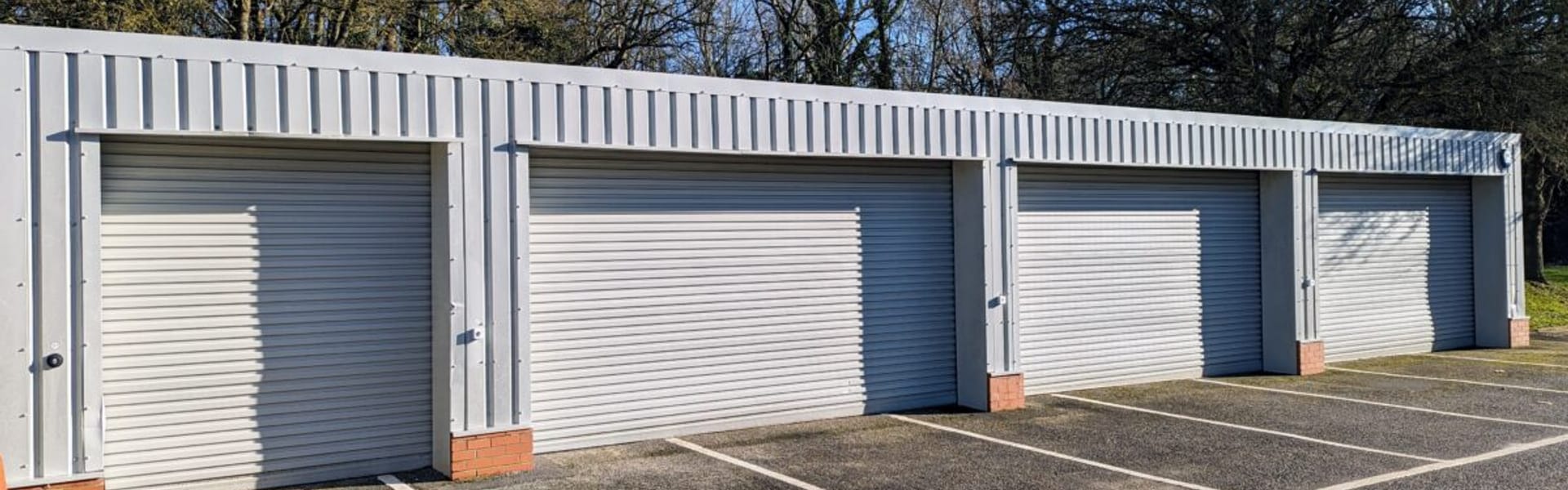 A row of roller-shutter lock-up garages at Watermoor Point